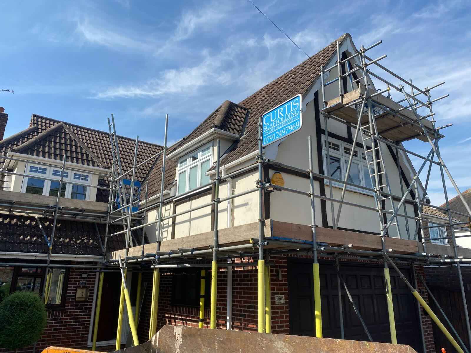 Scaffold and Curtis Scaffolding sign around house